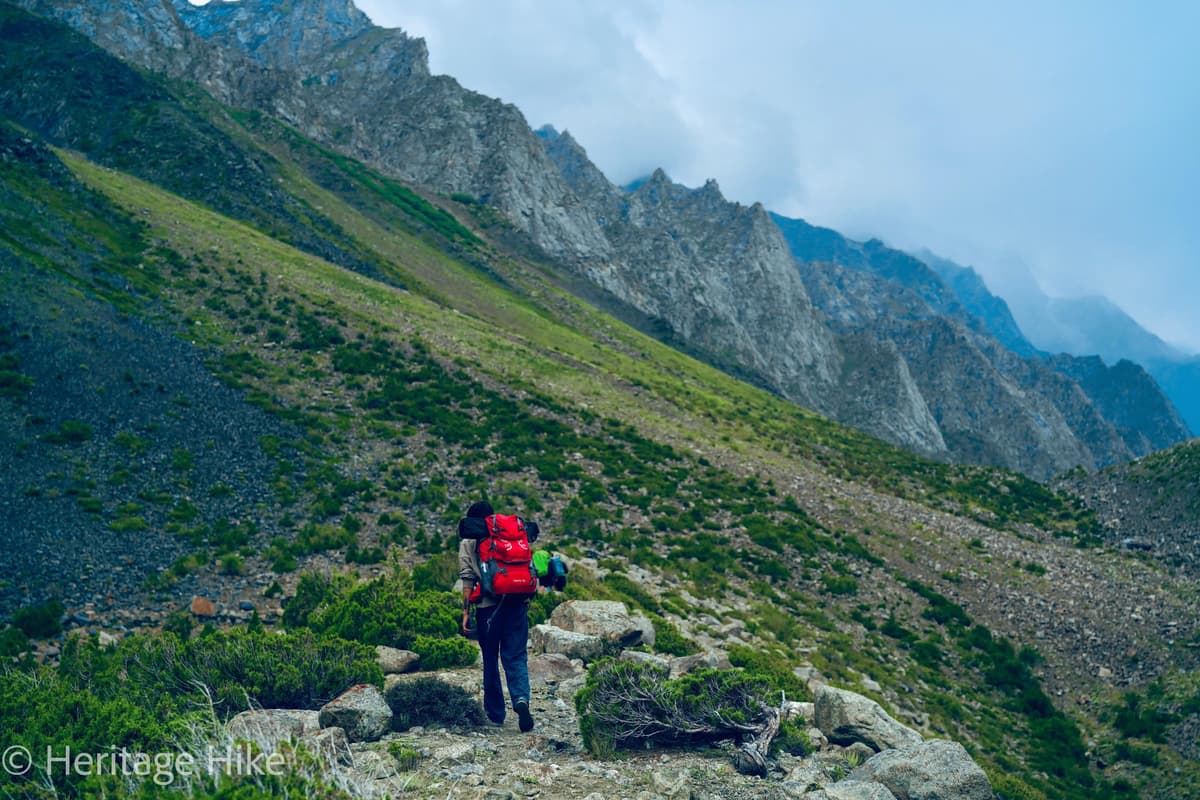 Kharmang Valley along the Indus River in Baltistan with dramatic ochre and grey gorge walls and a glimpse of traditional Balti settlements