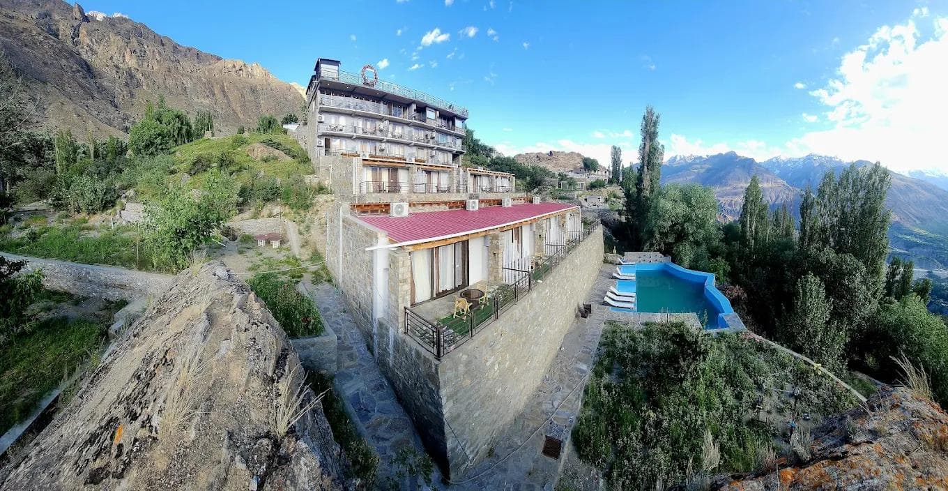 Hard Rock Hunza Resort sky bar terrace with 360-degree views of Rakaposhi and Lady Finger peaks at dusk